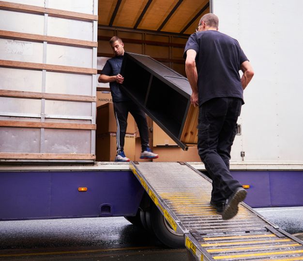 Removalists loading furniture into a removal truck